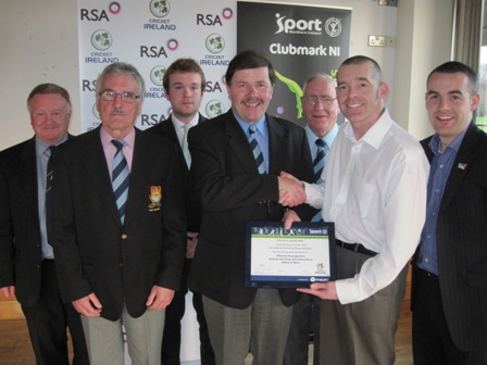 Carrickfergus Vice President and Northern Cricket Union Chairman Roger Bell receives the Club Accreditation Scheme certificate from Cricket Ireland’s Tim Simmonite. They are alongside Sport Northern Ireland Performance Consultant Simon Toole and representatives from the club including Ireland international Paul Stirling.